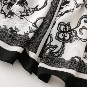 Close-up detail of black and white floral print scarf, vintage cotton linen shawl fabric.
