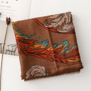 Detailed view of a vintage brown printed scarf with colorful feather pattern and fringe edge.