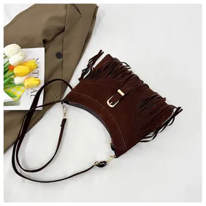 Brown suede fringe shoulder bag for women, retro crossbody purse with metal buckle detail.