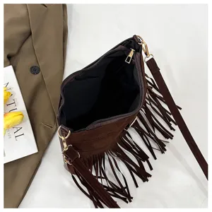 Brown suede fringe crossbody bag detail, showing interior opening and stylish retro design.
