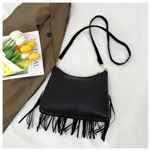 Detail shot of the stylish black fringe crossbody shoulder bag with delicate metallic hardware.