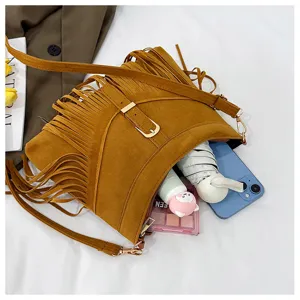 Brown suede fringe crossbody bag detail, vintage shoulder bag with capacity display.