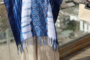 Λεπτομέρεια πόντσο σάλι με μπλε τύπωμα tie-dye, κρόσσια εθνοτικό στυλ κάπα ηλίου.