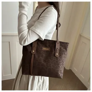Detail shot of the brown leopard print tote shoulder bag, showing PU leather straps and patch.