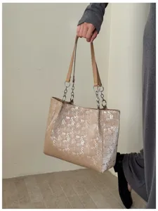 Close-up detail of the stylish large capacity tote bag with silver number print and chain straps.