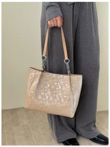Stylish large capacity tote bag with sequin number print and chain straps for daily commute.