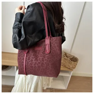 Leopard print tote bag detail showing shoulder strap and premium leather texture in scene.