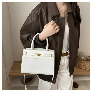 Vista detallada del elegante bolso de mano de mujer en cuero blanco con detalles dorados.
