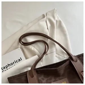 Brown leopard print tote bag detail view, stylish commuter shoulder bag with leather handles.