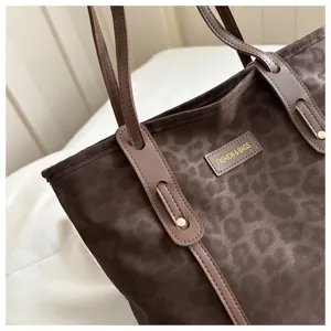 Brown leopard print tote bag detail showing premium fabric and twin shoulder straps.