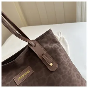 Leopard print tote bag detail, retro commuter shoulder bag with stylish patch and double straps.