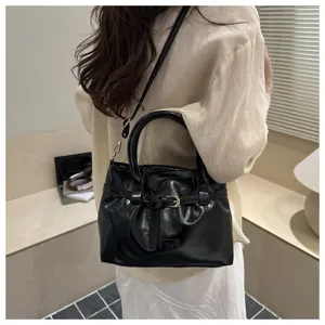 Black glossy leather handbag for women, retro commuter shoulder and crossbody bag.