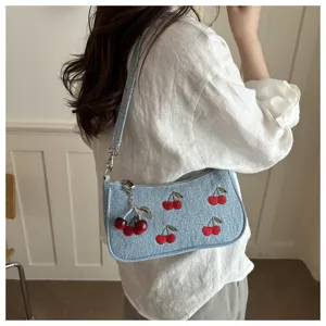 Chic denim shoulder bag with embroidered cherry pattern and cute metal charm for women.