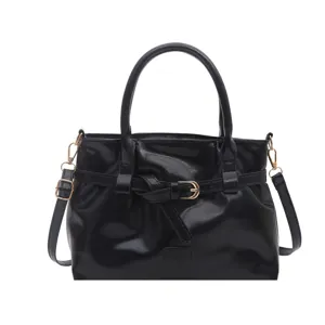 Black patent leather handbag for women, vintage shoulder bag with belt and gold hardware.