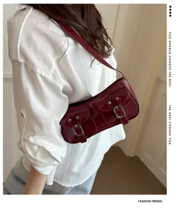 Retro red patent leather shoulder baguette bag with stylish double front pockets.