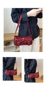 Detail shot of retro patent leather shoulder bag with double pockets and metal buckle accents.