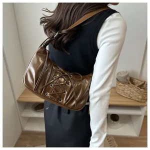 Vue détaillée du sac porté épaule marron plissé élégant avec un laçage tendance.