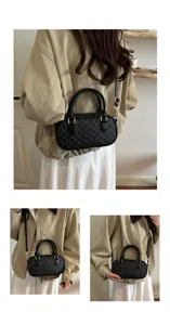 Schwarze Monogramm Schultertasche für Damen, stilvolle Zylinder Umhängetasche für den Alltag.