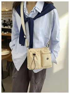 Lightweight nylon multi-functional crossbody shoulder bag with multiple pockets for daily commute.