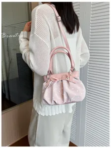 Chic pink polka dot handbag for women, versatile pleated shoulder crossbody bag for daily use.