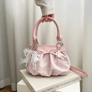 Korean style pink polka dot handbag with bow and pearl pendant, cute shoulder messenger bag.