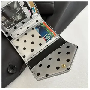 Stylish silver polka dot folding wallet card holder with multiple slots and chic design.