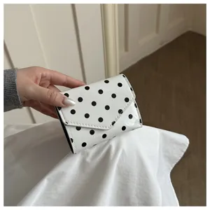 Chic black and white polka dot short wallet, compact folding design for daily style use.