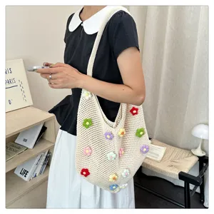 Vue détaillée du sac porté épaule en crochet beige avec fleurs tricotées, scène lifestyle.