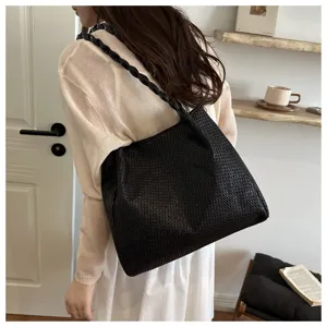 Detailed view of women large capacity black woven shoulder tote bag, casual commuting style.