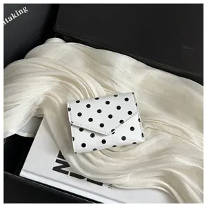 Chic white polka dot small wallet for women, stylish tri-fold mini purse with compact design.