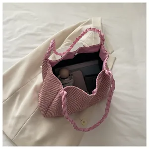 Pink houndstooth woven tote bag detail showing large capacity interior, stylish braided handles.