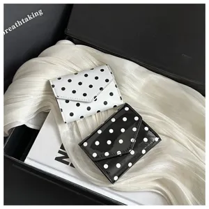 Chic polka dot mini wallet for women, stylish trifold compact purse with cute pattern.