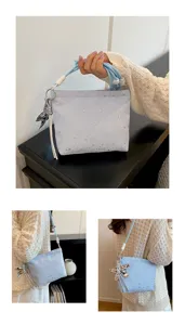 Light blue star pattern crossbody bag detail shot, stylish handbag with strap and star charm.
