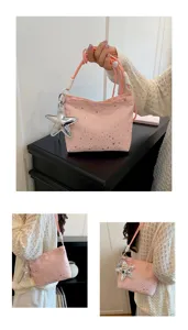 Pink star print handbag detail view featuring silver star pendant and soft rope handles.