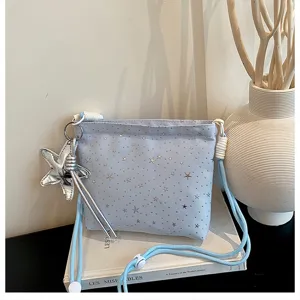 Light blue fabric crossbody bag with silver star charm and cute star pattern for women daily use.