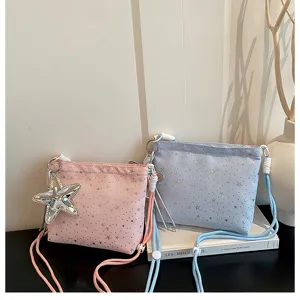 Detail shot of stylish canvas crossbody bags featuring star patterns and a cute star pendant.
