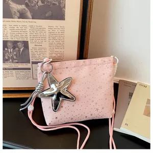 Detailed view of the pink crossbody bag with silver star pendant and cute star pattern prints.