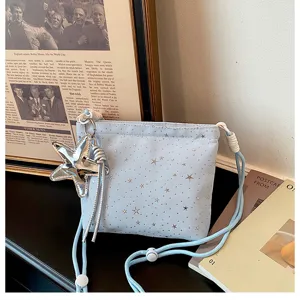 Light blue star print crossbody bag featuring a shiny silver starfish pendant and drawstring.