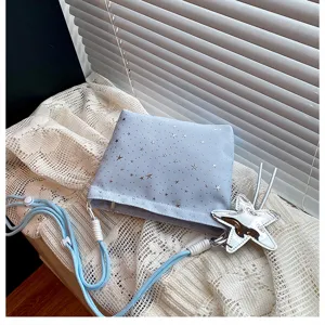 Light blue star print crossbody bag with star charm and adjustable strap for women.