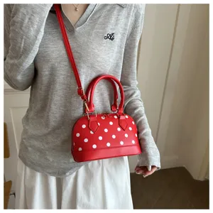 Stylish red polka dot dome handbag for women, elegant leather crossbody and shoulder bag.