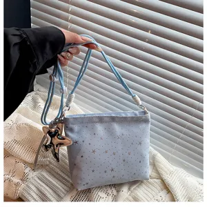 Detailed view of the trendy light blue star pattern cross-body small bag with chic star pendant.