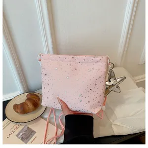 Pink star print crossbody mini bag detail view, showing soft fabric and cute star pendant.