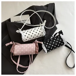 Graziosa borsa a tracolla cilindrica a pois per ragazze con finiture in pizzo e sottile cinturino.