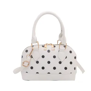 Chic white polka dot dome handbag for women, stylish PU leather crossbody shell bag.