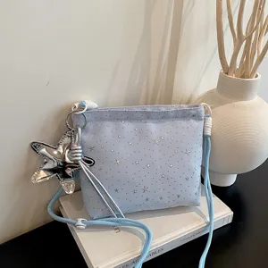 Light blue crossbody bag with silver star prints and star pendant for women daily chic casual style