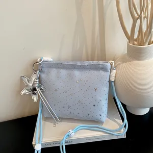 Light blue canvas crossbody bag with silver star print, cute star pendant and strap.