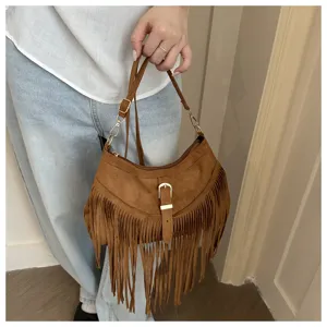 Retro brown suede fringe shoulder bag for women, stylish western underarm saddle bag.