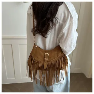 Retro brown suede fringe shoulder bag detail showing texture and metal buckle strap.