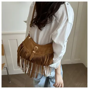 Western retro suede fringe underarm bag for women, stylish boho shoulder saddle bag detail.