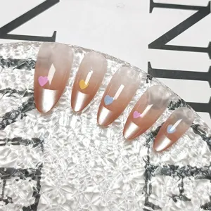 Detail shot of handmade press-on nails featuring cat-eye gradient and cute heart design.
